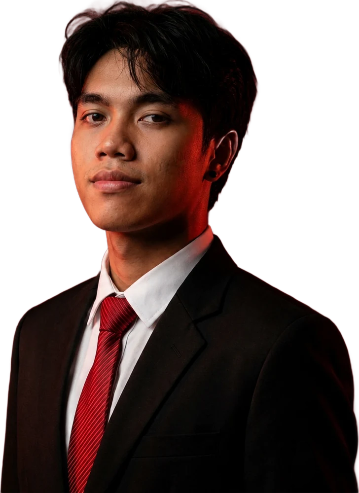 Portrait of Jhade in a black suit and red tie